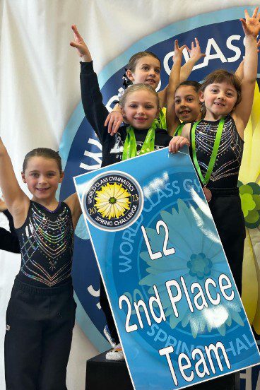 Gymnastics team celebrating second place win.